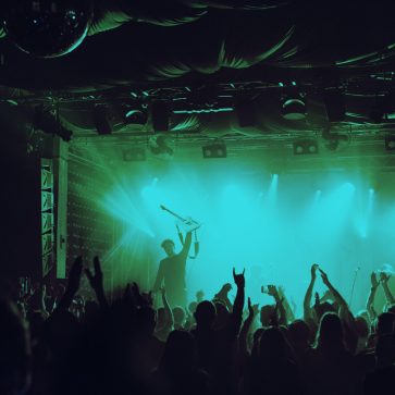 Cheering crowd having fun at music festival in a nightclub