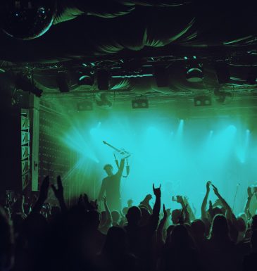 Cheering crowd having fun at music festival in a nightclub